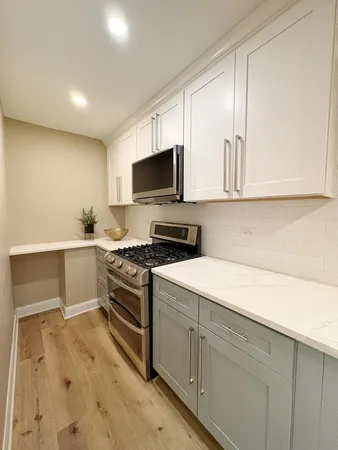 a kitchen with a sink and white cabinets