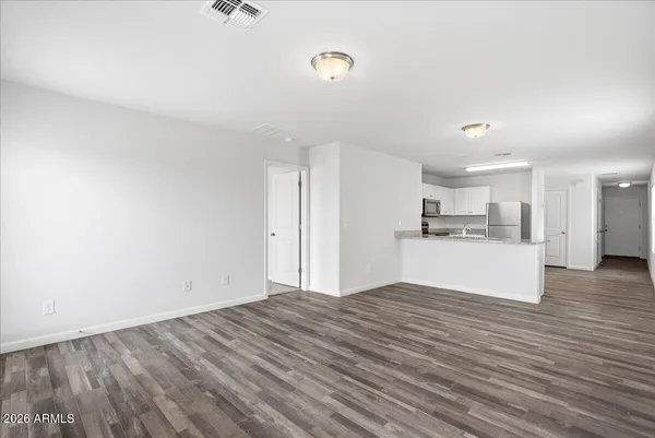 a kitchen with stainless steel appliances a refrigerator sink and microwave