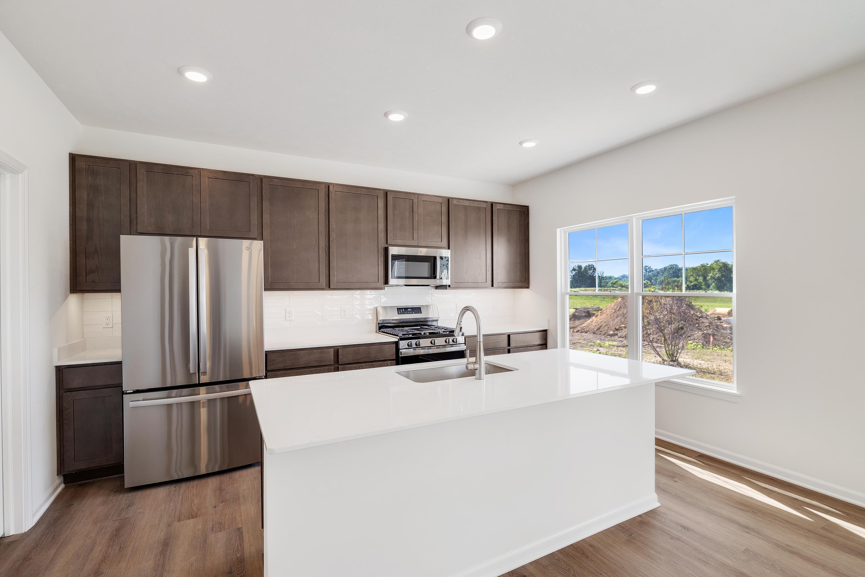 3755 Lookout Road Valparaiso, IN 46385 - Photo 6 of 21 a kitchen with kitchen island a counter top space a refrigerator a stove a sink and a window