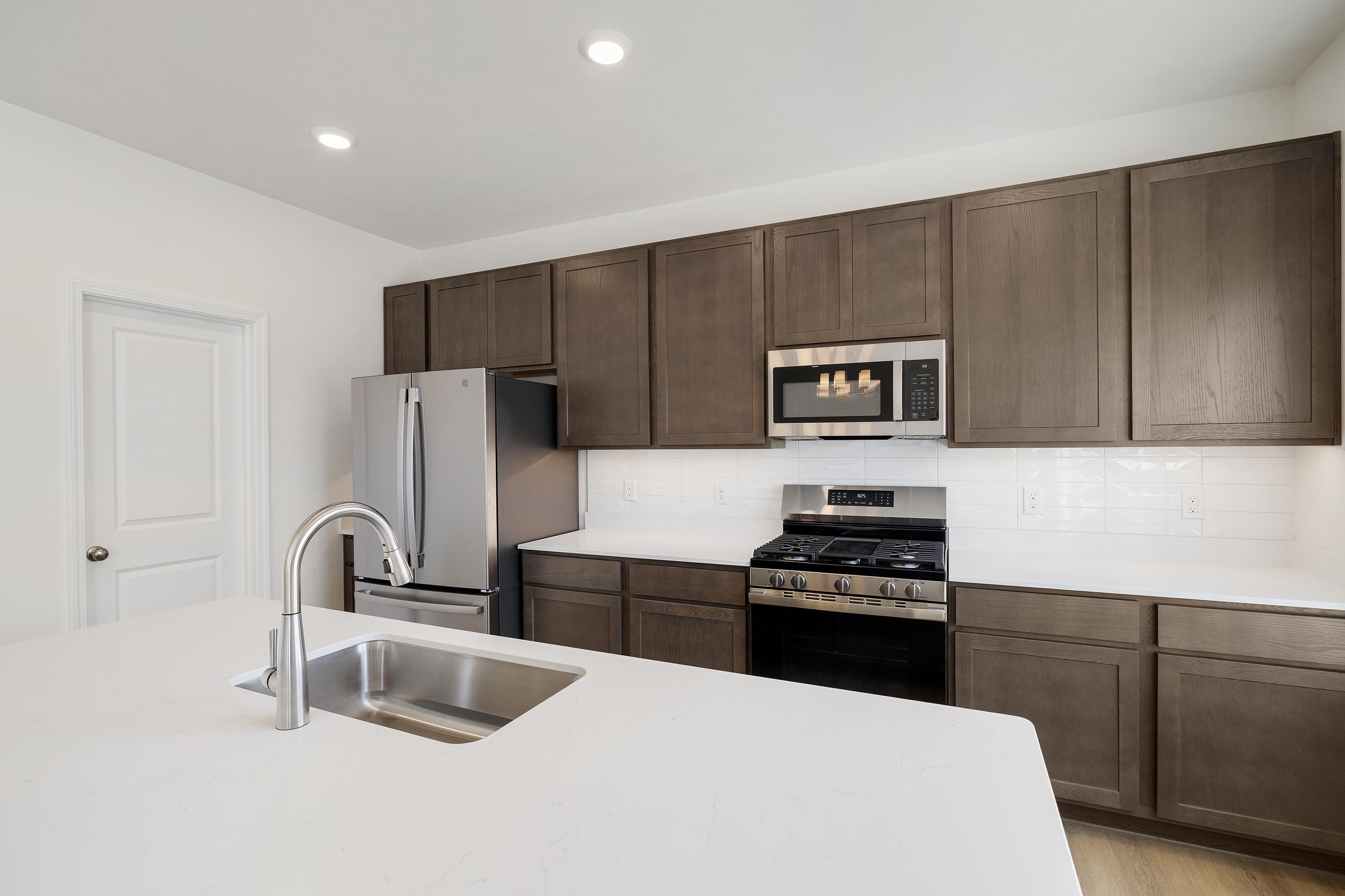 3755 Lookout Road Valparaiso, IN 46385 - Photo 8 of 21 a kitchen with granite countertop a refrigerator and a sink