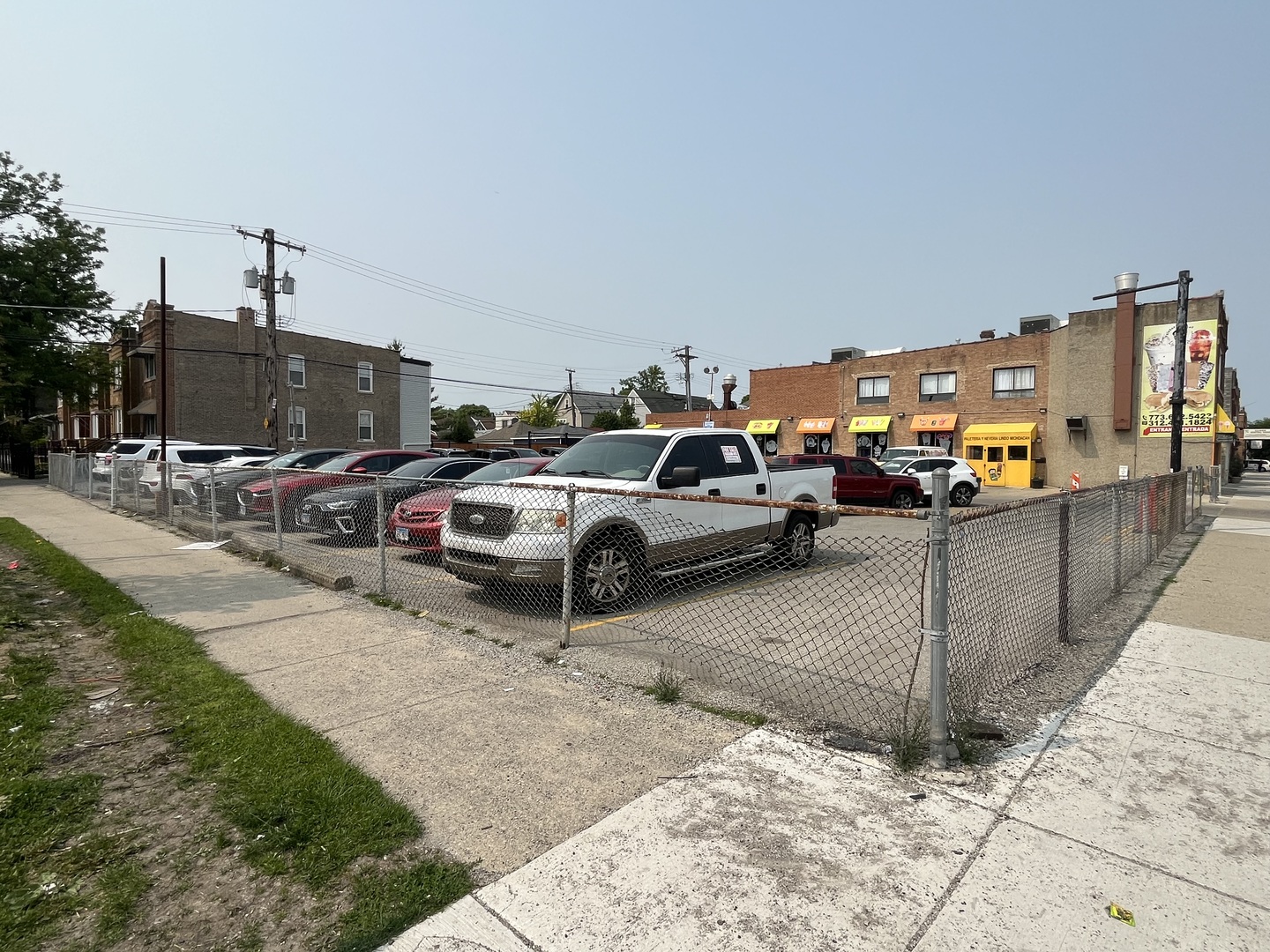 5243 West Fullerton Avenue Chicago, IL 60639 - Photo 2 of 2 a view of a cars park in front of a building