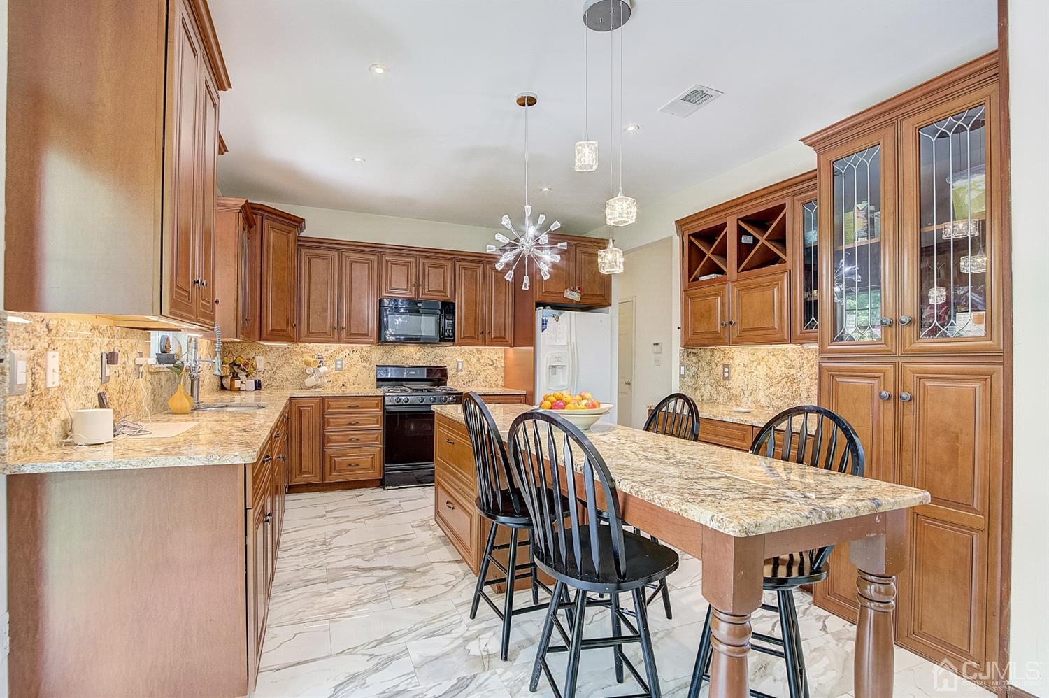 13 Revere Road Monmouth Junction, NJ 08852 - Photo 11 of 39 a kitchen with granite countertop a sink and a refrigerator