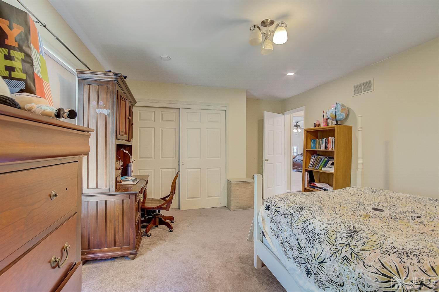 13 Revere Road Monmouth Junction, NJ 08852 - Photo 15 of 39 a bedroom with a bed and a chandelier