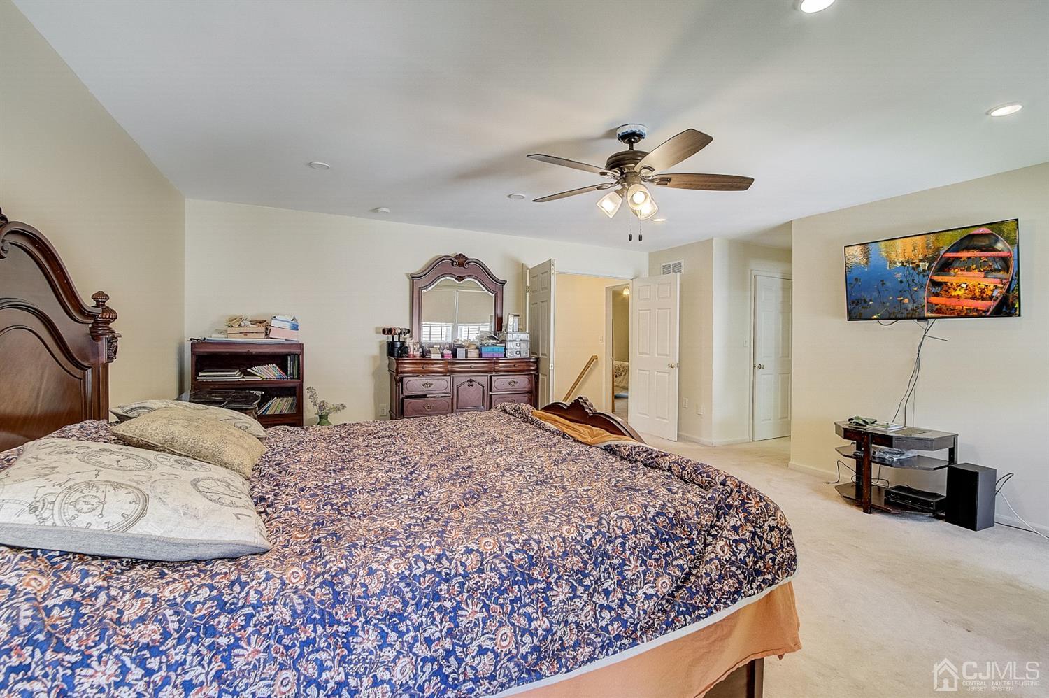 13 Revere Road Monmouth Junction, NJ 08852 - Photo 24 of 39 a bedroom with a large bed and a chandelier