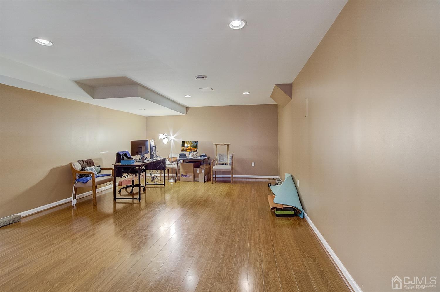 13 Revere Road Monmouth Junction, NJ 08852 - Photo 33 of 39 a view of a room with wooden floor furniture and a chandelier