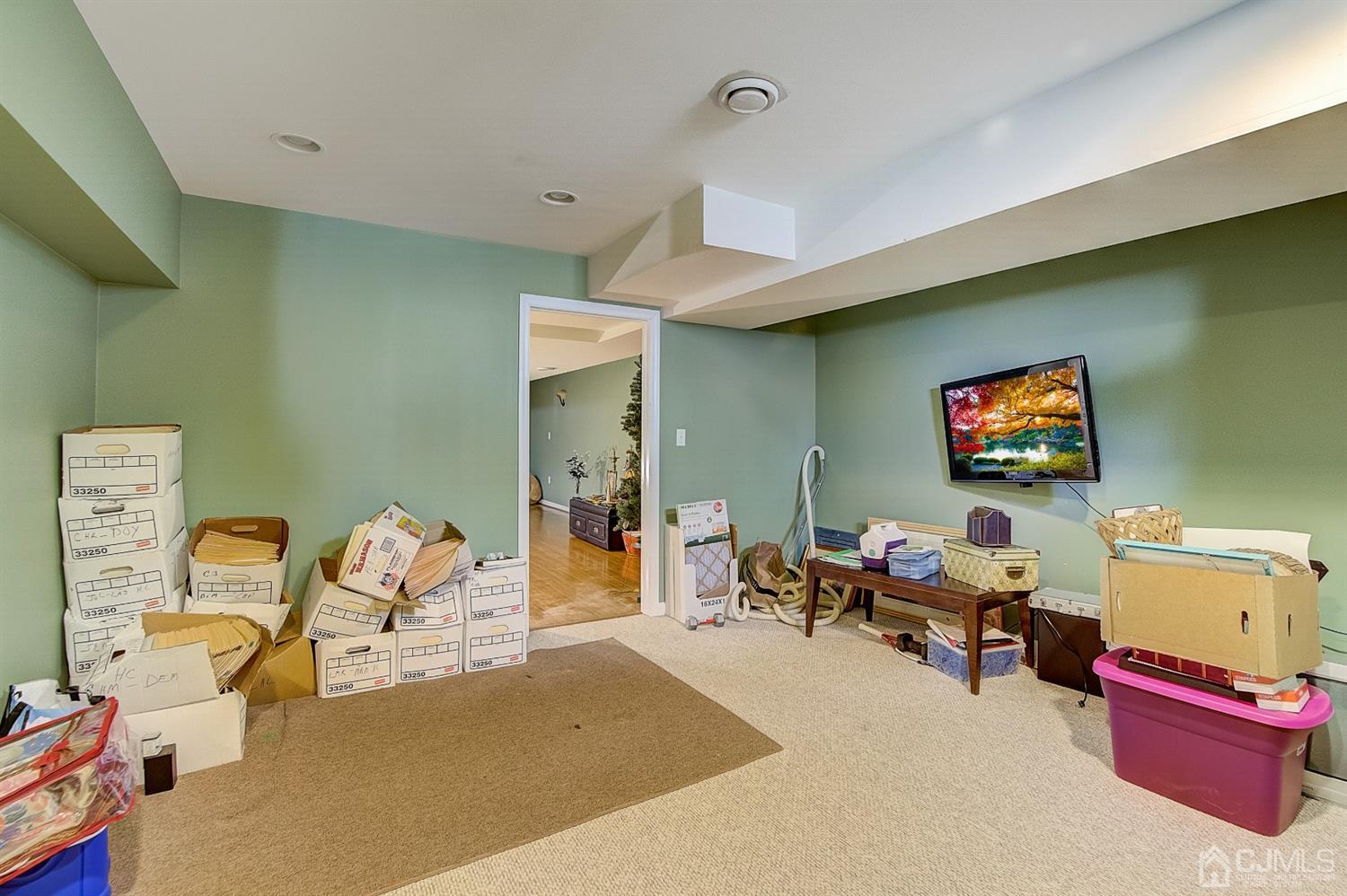 13 Revere Road Monmouth Junction, NJ 08852 - Photo 35 of 39 a living room with furniture and a flat screen tv