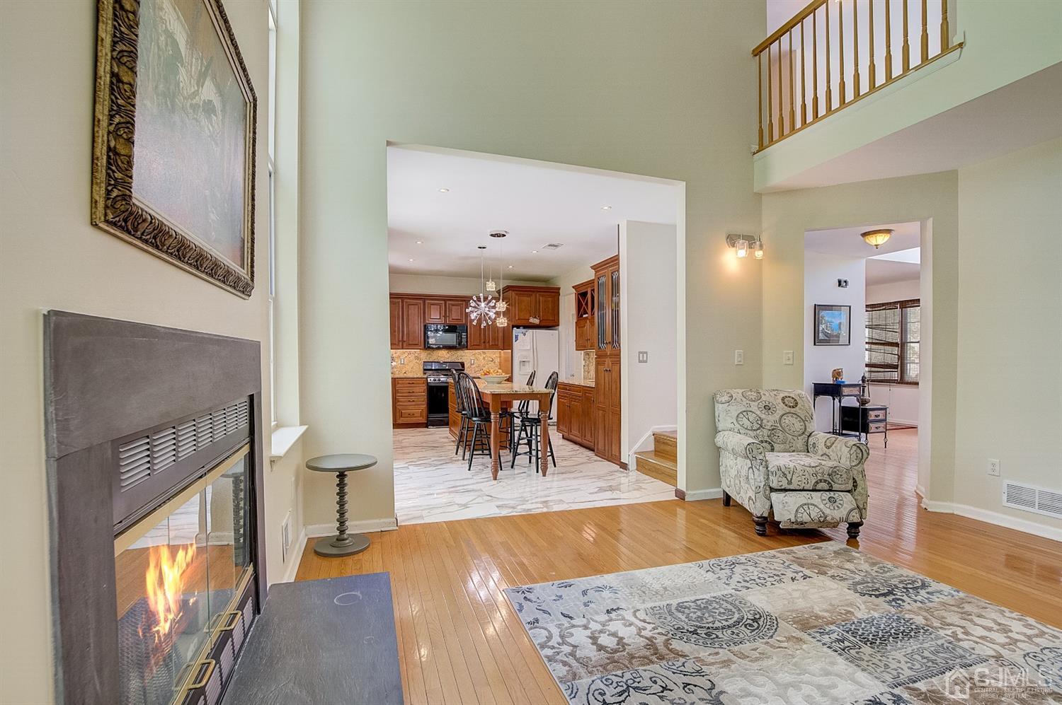 13 Revere Road Monmouth Junction, NJ 08852 - Photo 8 of 39 a living room with furniture and a dining table with wooden floor