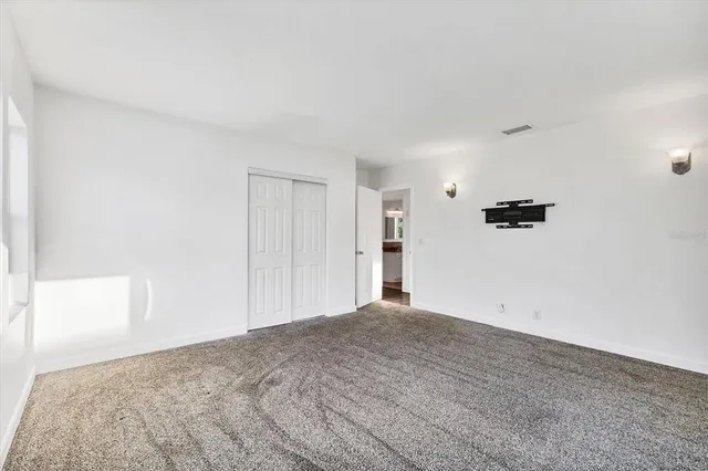 a bathroom with a granite countertop sink a toilet and a mirror