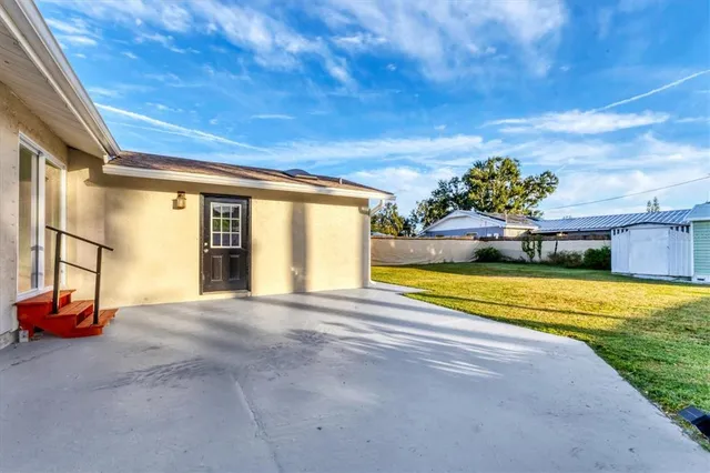 a view of a house with swimming pool and a yard
