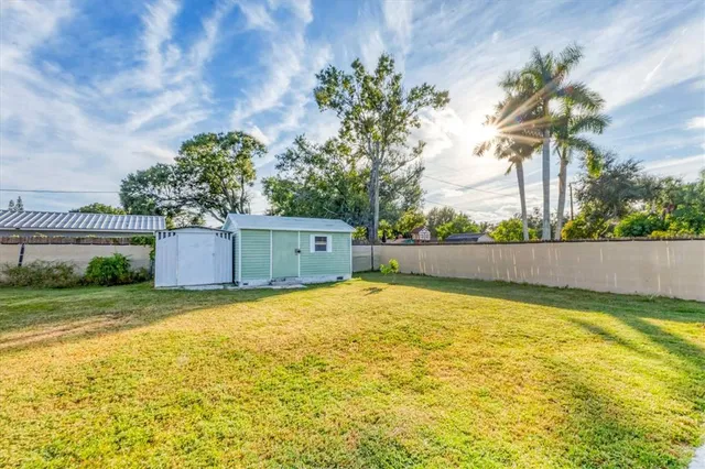 a view of a house with swimming pool and a yard