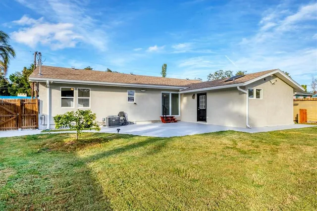 a aerial view of a house with a yard