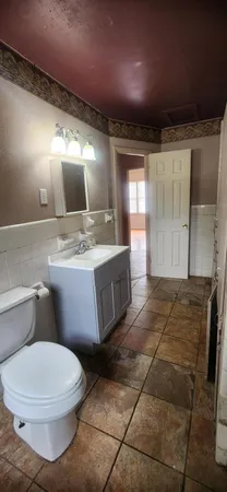 a bathroom with a sink a toilet and mirror