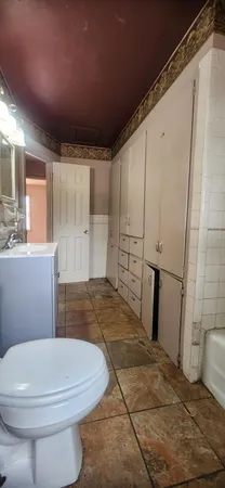 a bathroom with a sink a toilet a mirror and shower