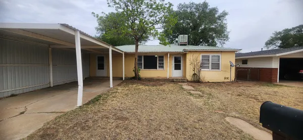 a view of house with backyard and seating space