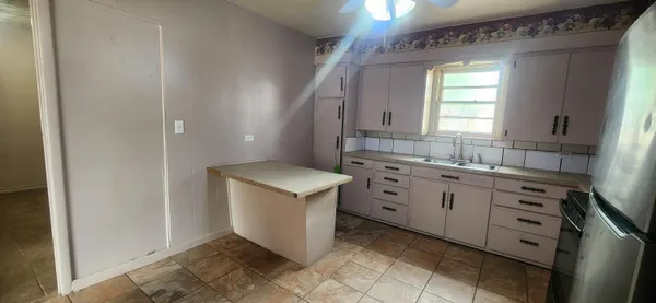 a spacious bathroom with a shower sink and mirror