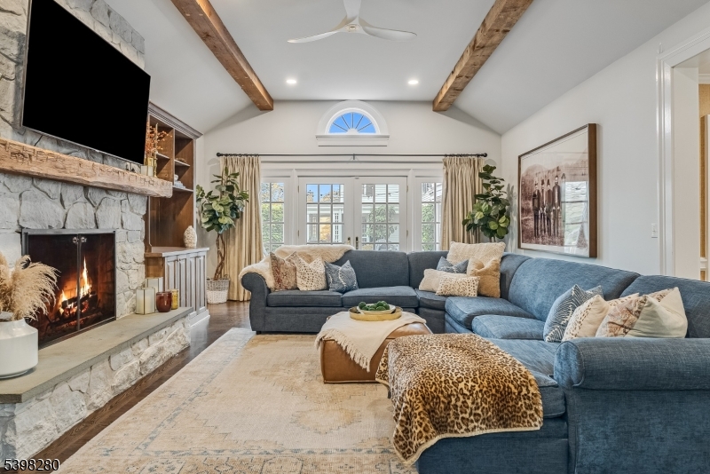 22 Talmage Road Mendham, NJ 07945 - Photo 12 of 46 a living room with furniture a flat screen tv and a fireplace