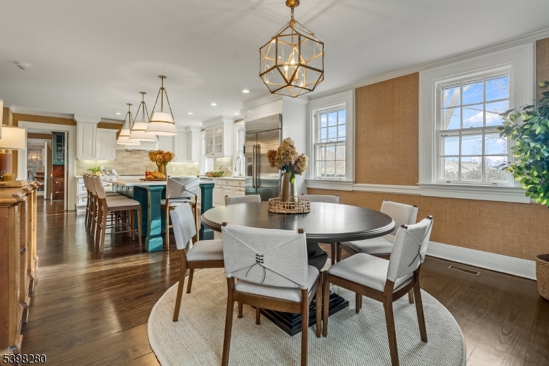 22 Talmage Road Mendham, NJ 07945 - Photo 20 of 46 a dining room with wooden floor a chandelier a glass table and chairs