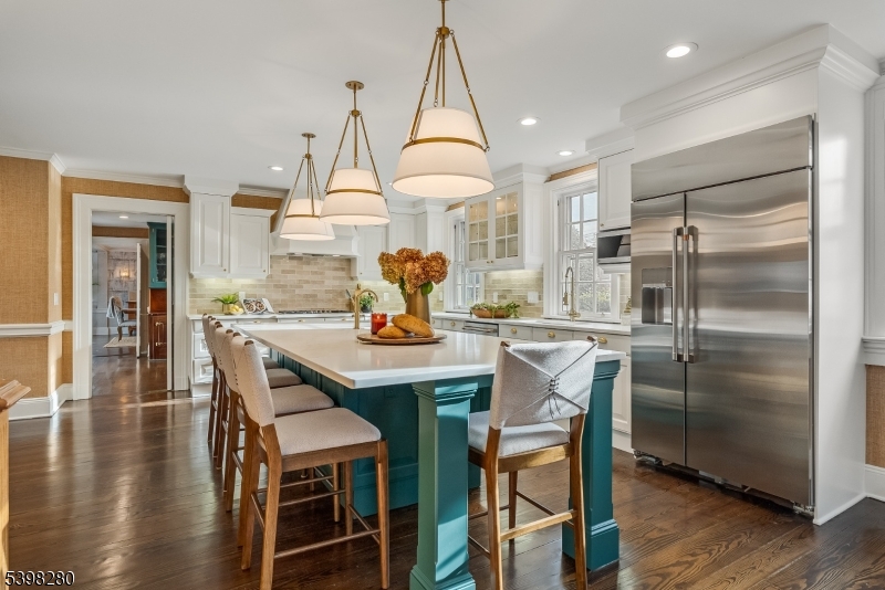22 Talmage Road Mendham, NJ 07945 - Photo 21 of 46 a kitchen with stainless steel appliances a dining table chairs and wooden floor
