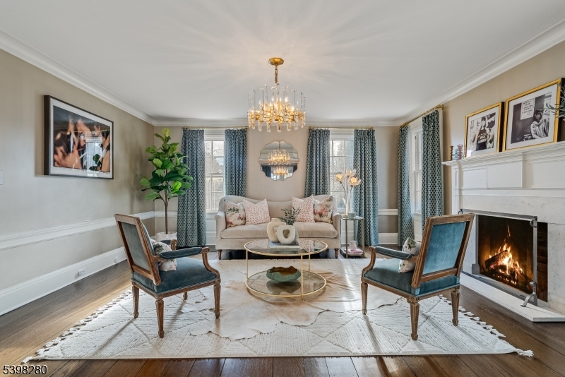 22 Talmage Road Mendham, NJ 07945 - Photo 28 of 46 a living room with furniture a fireplace and a chandelier