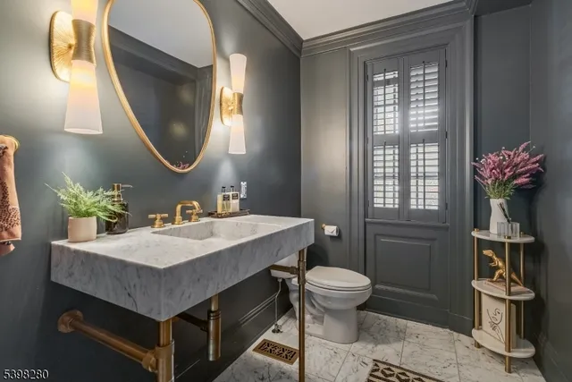 a bathroom with a sink toilet and a mirror