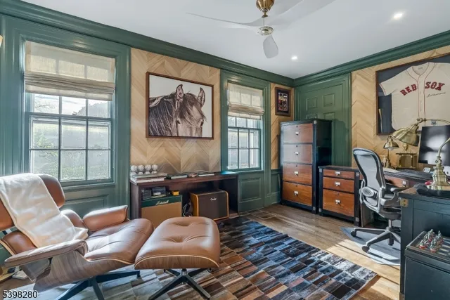 a room with a black white checkered floor with a gaming machine and a rug