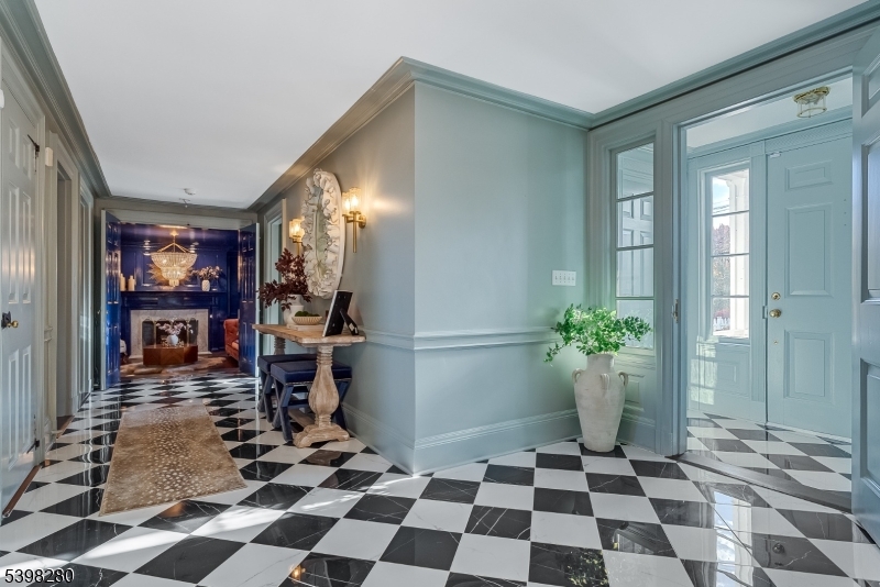 22 Talmage Road Mendham, NJ 07945 - Photo 33 of 46 a room with a black white checkered floor with a gaming machine and a rug