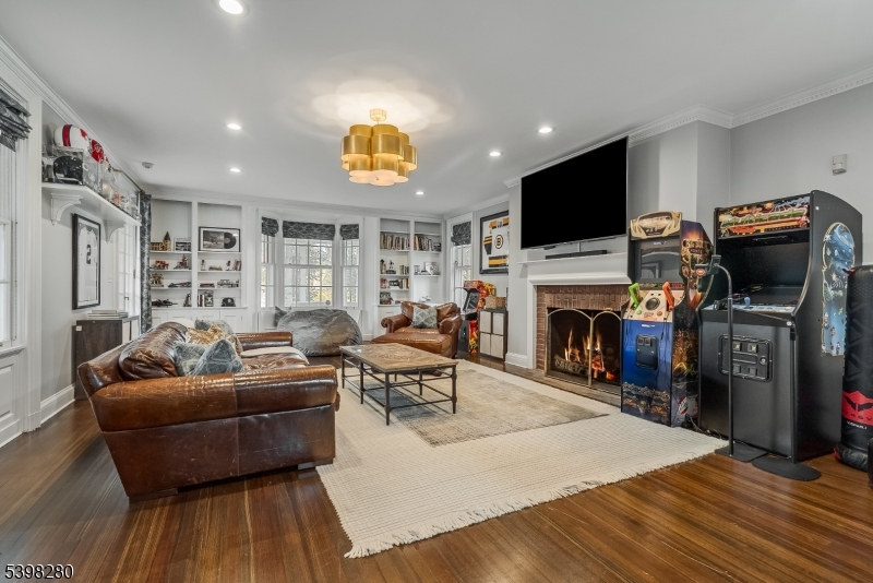 22 Talmage Road Mendham, NJ 07945 - Photo 36 of 46 a living room with furniture a flat screen tv and a fireplace