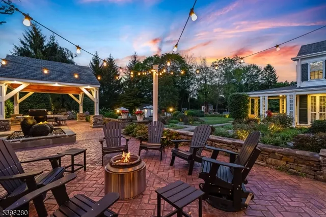 a view of a patio with dining table and chairs with a fire pit