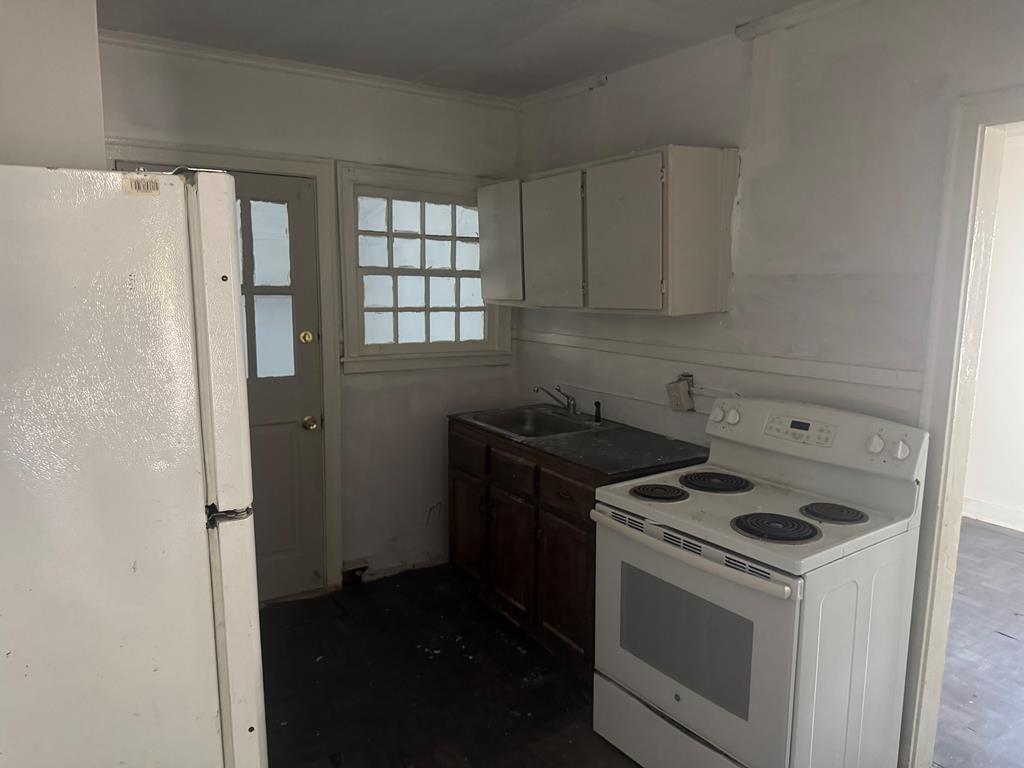 2916 Lee Street Columbus, GA 31903 - Photo 4 of 11 a kitchen with a stove and a refrigerator