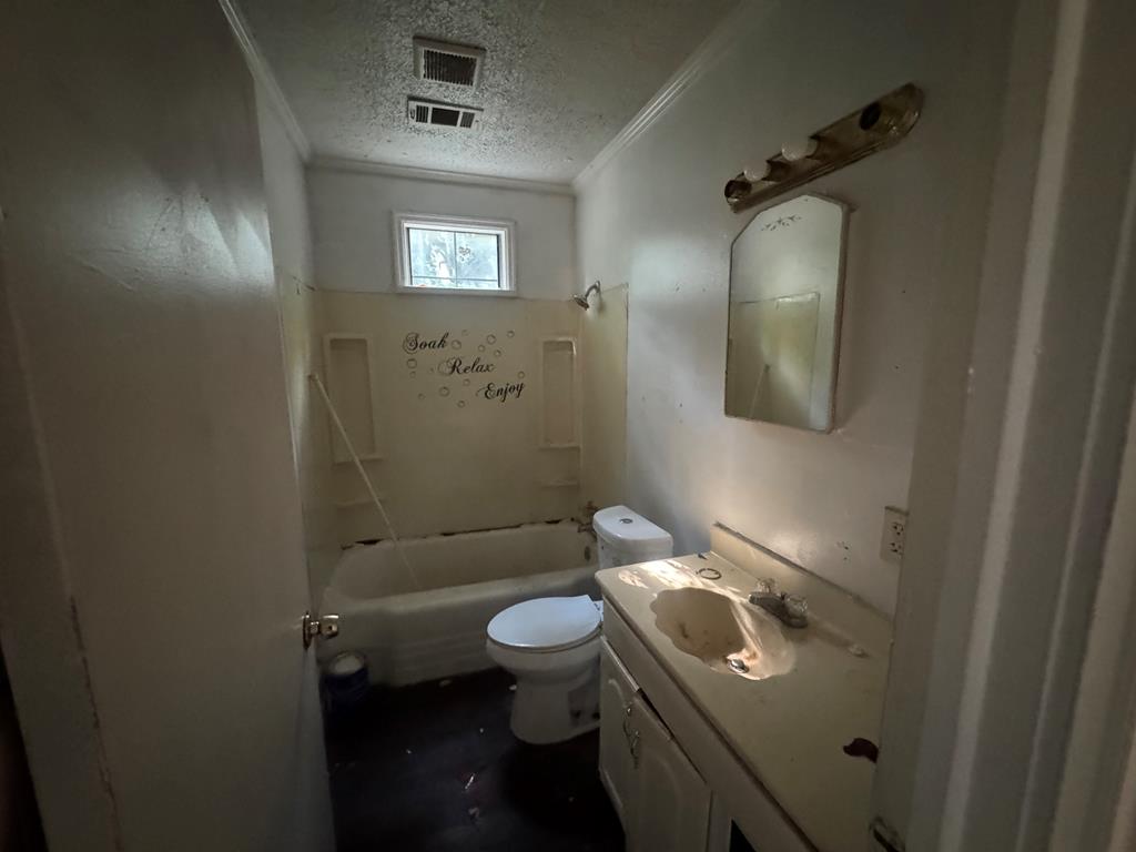2916 Lee Street Columbus, GA 31903 - Photo 8 of 11 a bathroom with a toilet a sink and mirror