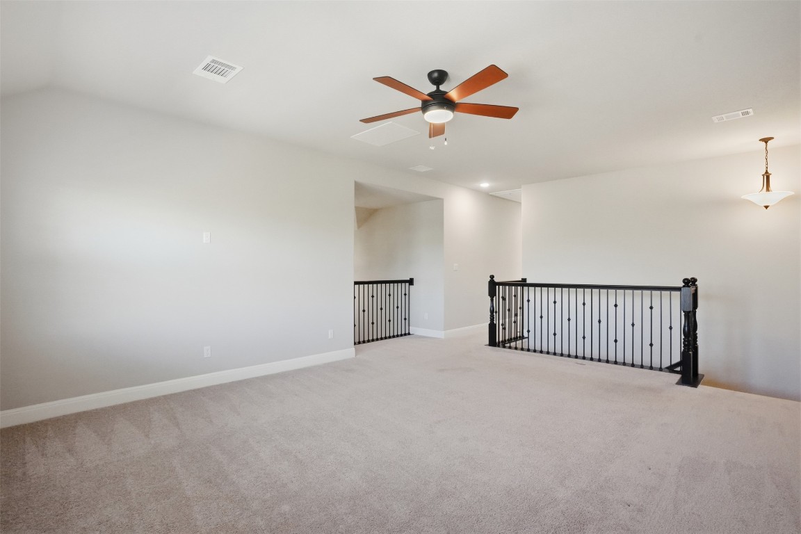 1441 River Vista Road Georgetown, TX 78628 - Photo 28 of 37 Empty room with light colored carpet, a ceiling fan, and vaulted ceiling