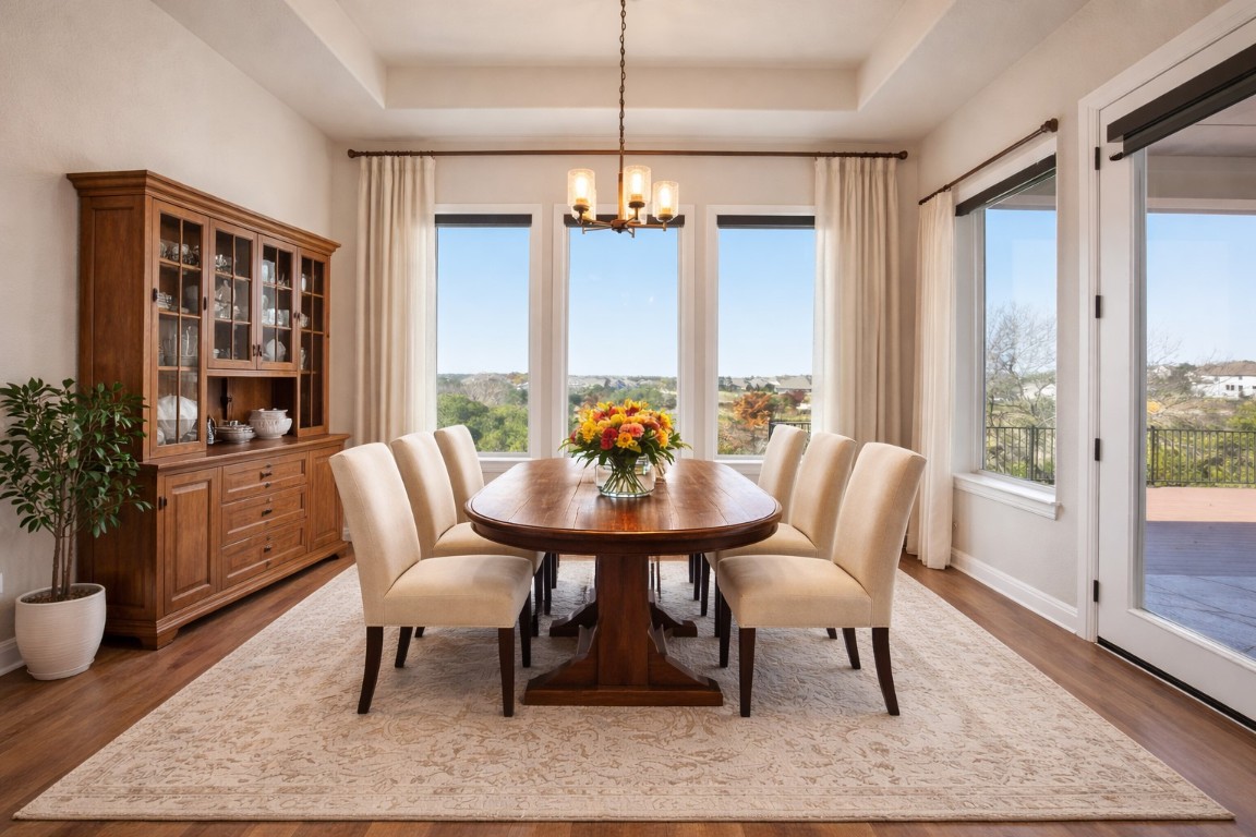1441 River Vista Road Georgetown, TX 78628 - Photo 36 of 37 Virtually stage Dining space with a chandelier, wood finished floors, and a raised ceiling