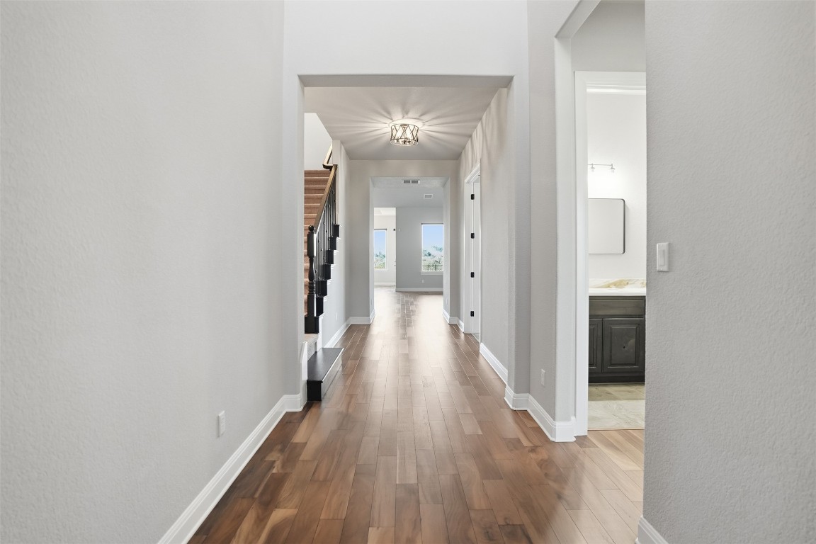 1441 River Vista Road Georgetown, TX 78628 - Photo 6 of 37 Hall with Acacia floors, stairway leads to upstairs gameroom.