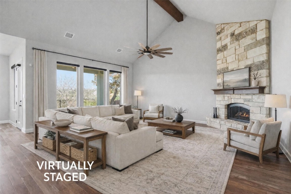 1441 River Vista Road Georgetown, TX 78628 - Photo 8 of 37 Living room with a stone fireplace, wood finished floors, high vaulted ceiling, beamed ceiling, and a ceiling fan