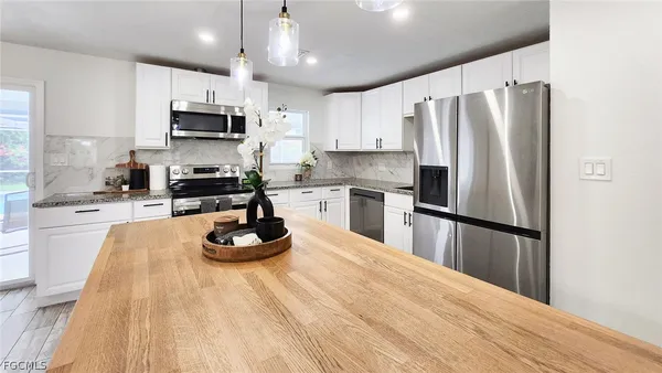 a kitchen with stainless steel appliances a refrigerator sink microwave stove and refrigerator