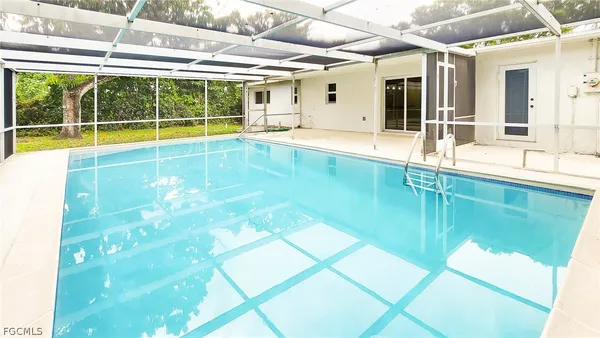 a swimming pool with outdoor seating and yard