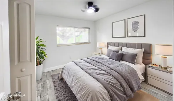 a bedroom with bed and a window