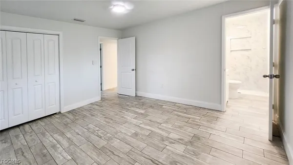 a view of an empty room and wooden floor