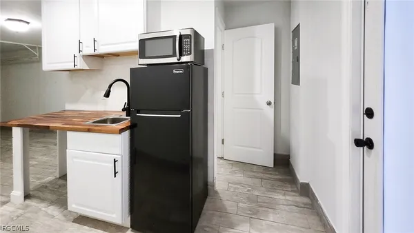 a kitchen with refrigerator and cabinets