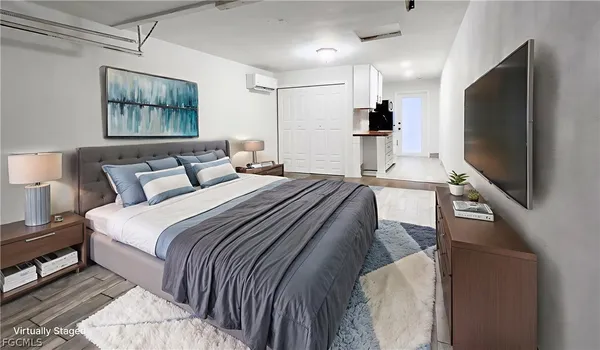 a bedroom with a bed and a flat screen tv