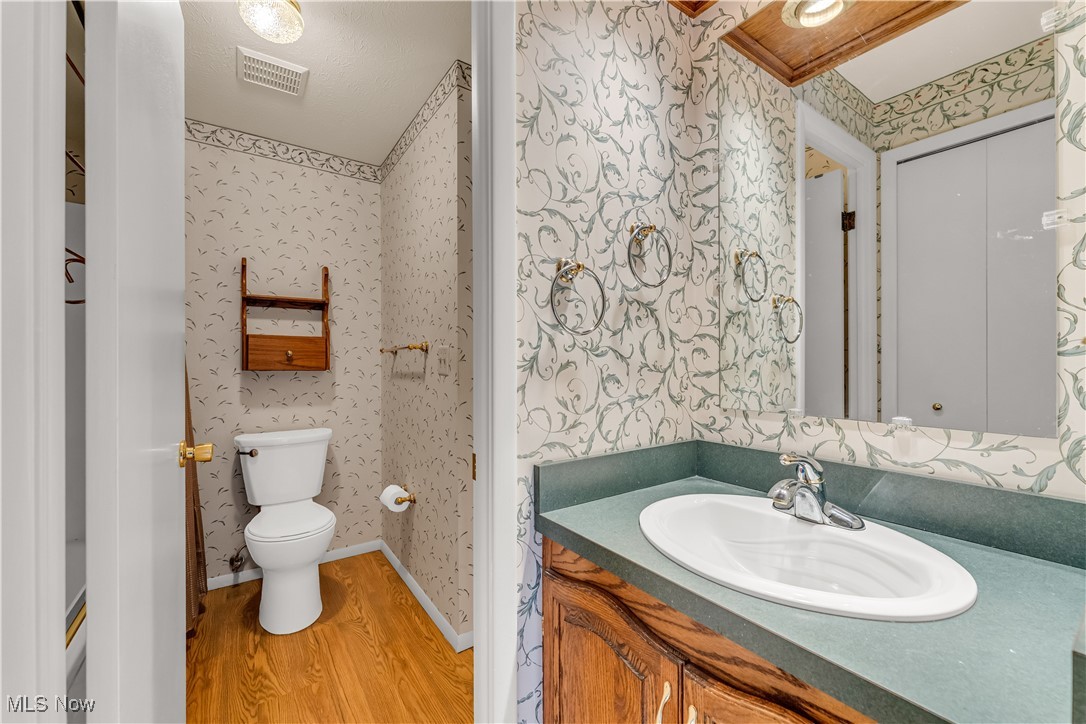 6470 State Road, Unit K5 Parma, OH 44134 - Photo 16 of 26 Bathroom featuring wallpapered walls, vanity, and light wood finished floors