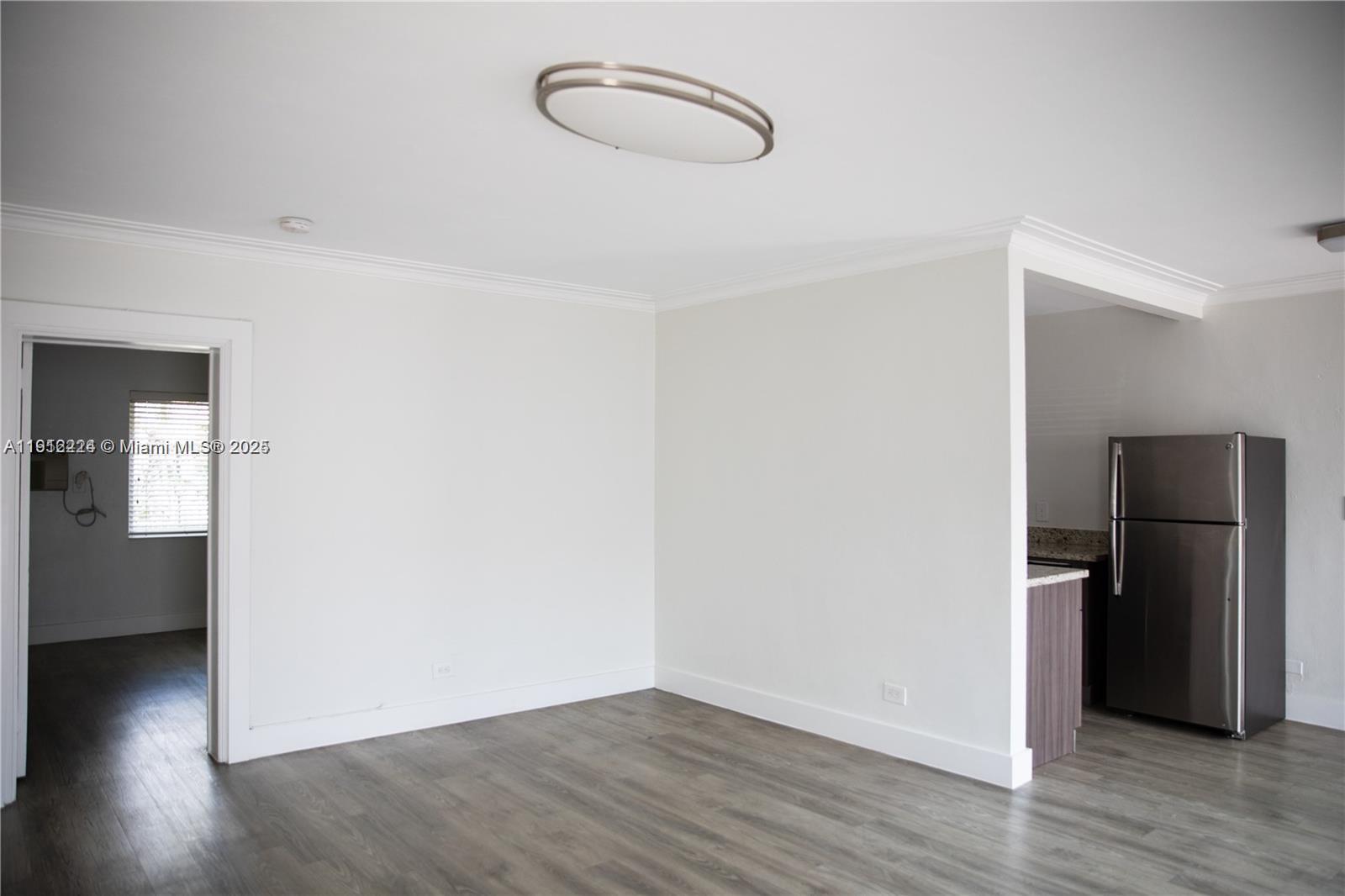 345 85th Street, Unit 7 Miami Beach, FL 33141 - Photo 13 of 13 a view of a room with wooden floor and a ceiling fan