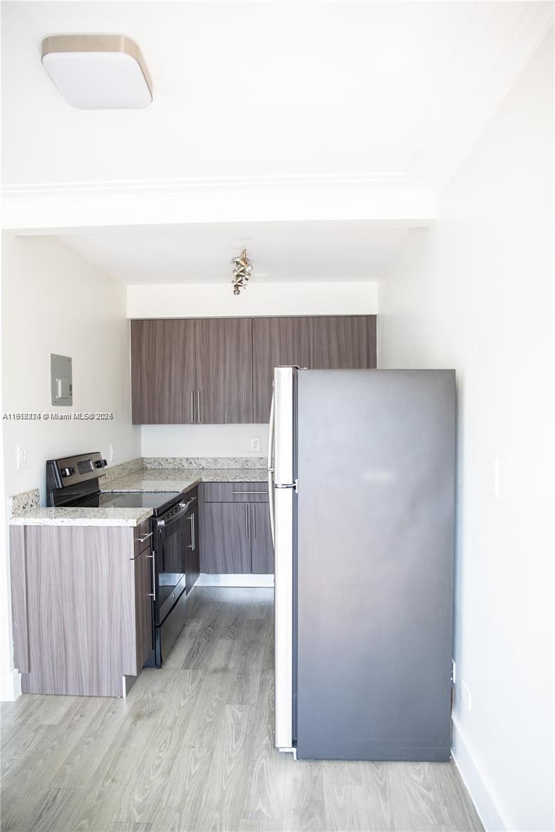 345 85th Street, Unit 7 Miami Beach, FL 33141 - Photo 4 of 13 a kitchen with a stove and a refrigerator