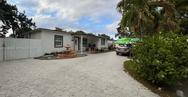a backyard of a house with fire pit and couches