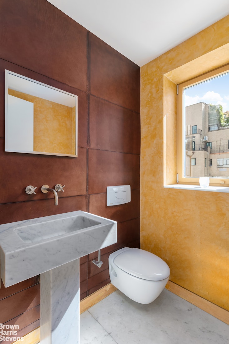 936 5th Avenue, Unit PH Manhattan, NY 10021 - Photo 20 of 21 a bathroom with a sink a toilet and mirror
