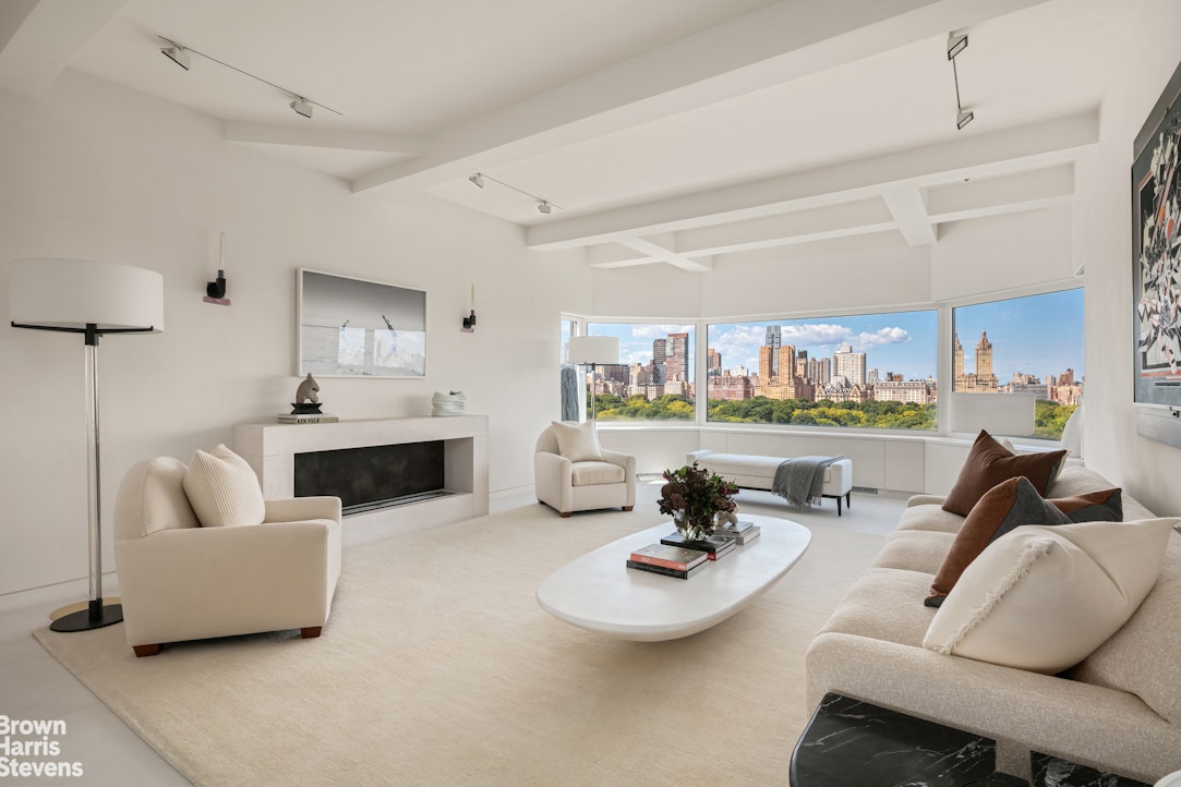 936 5th Avenue, Unit PH Manhattan, NY 10021 - Photo 3 of 21 a living room with furniture and a large window