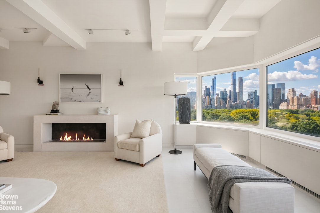 936 5th Avenue, Unit PH Manhattan, NY 10021 - Photo 4 of 21 a living room with furniture and a fireplace