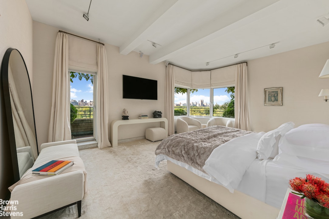 936 5th Avenue, Unit PH Manhattan, NY 10021 - Photo 6 of 21 a bedroom with a bed and a flat screen tv