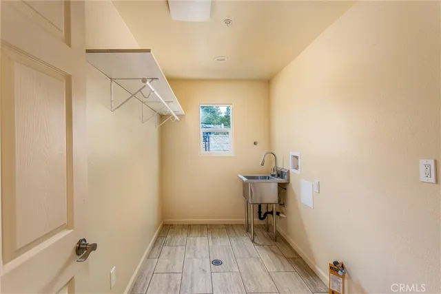 an empty room with wooden floor and window