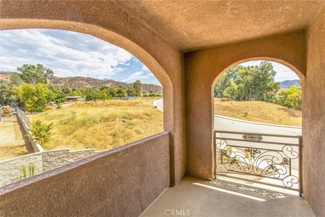 an empty room with wooden floor and entrance